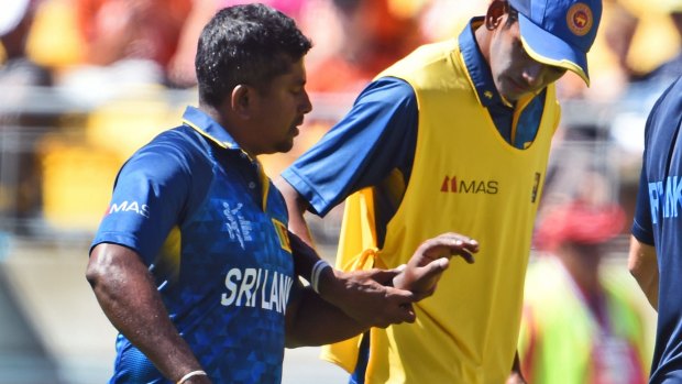 Sri Lanka spinner Rangana Herath walks off after injuring his hand against England.