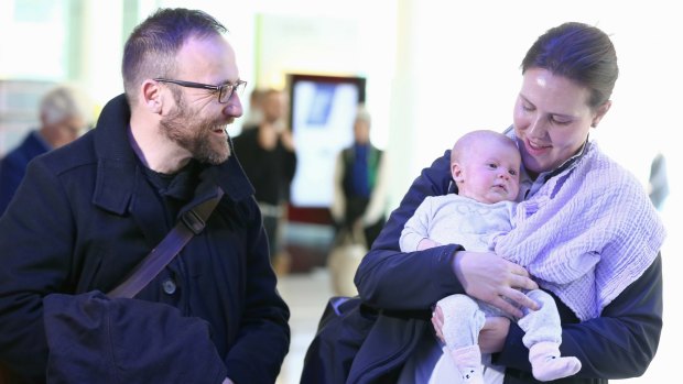 New father Greens MP Adam Bandt greets Ms O'Dwyer and Olivia at Canberra Airport, arriving for the return of Parliament this week.
