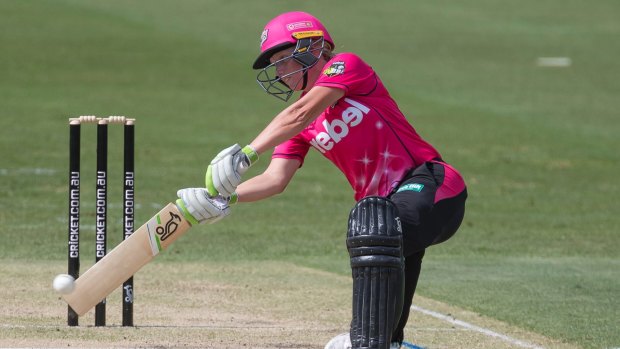 Seeing them like footballs: Alyssa Healy takes to the Strikers' attack yesterday.