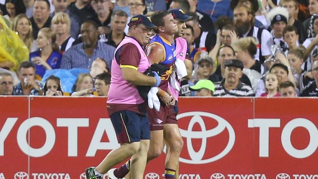 Tom Rockliff is taken from the field after being injured during the Lions' game against Collingwood.
