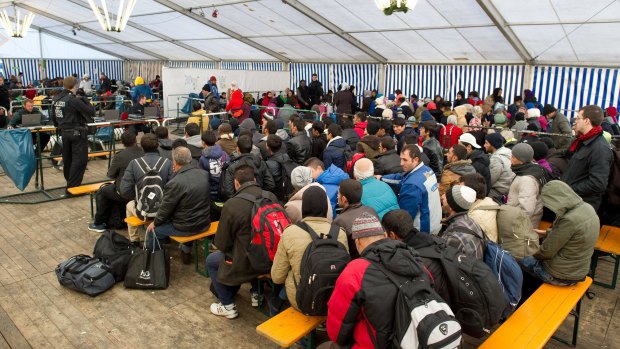 Refugees wait to be registered in a tent at the train station in the Bavarian city of Passau this month.
