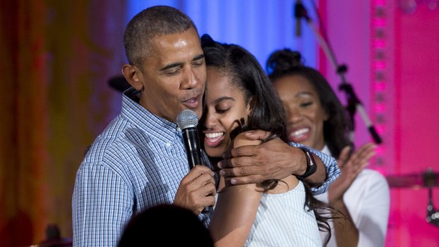 President Barack Obama hugs and sings "Happy Birthday" to his daughter at the White House.