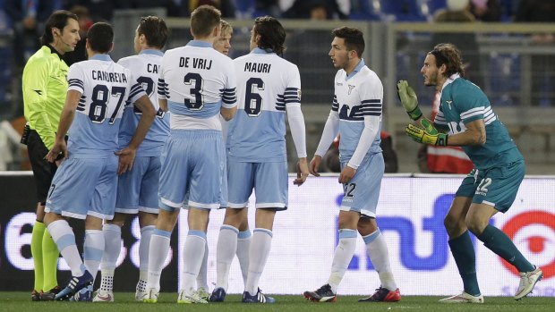 Lazio's keeper Federico Marchetti, right, argues with referee Andrea Gervasoni after being shown a red card.