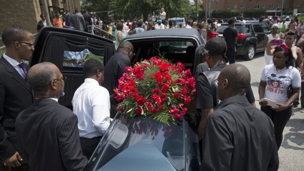 The casket of Samuel Dubose is transported to a hearse during his funeral in Cincinnati on Tuesday.