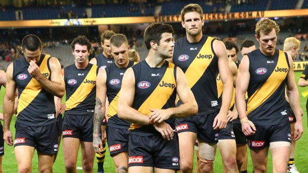 Trent Cotchin and the Tigers leave the field after losing to Port Adelaide.