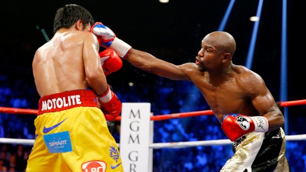 Floyd Mayweather jnr throws a right at Manny Pacquiao during their welterweight unification championship bout.
