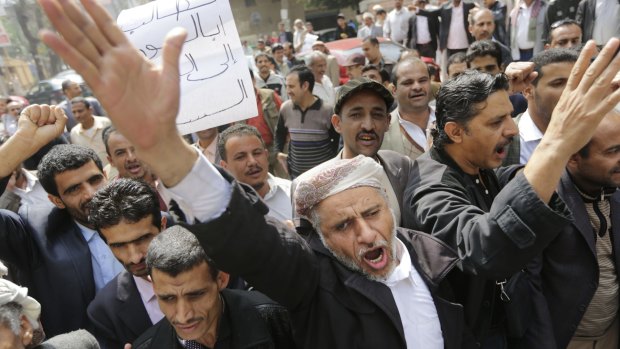 Huzam Mohammed al-Meghaly, 64, leads Yemeni expatriates in a protest outside Yemen's embassy in Cairo, demanding the right to return home.