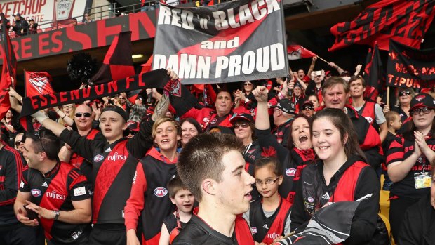 Red and back: Bomber Zach Merrett celebrates with supporters after the win over Gold Coast.