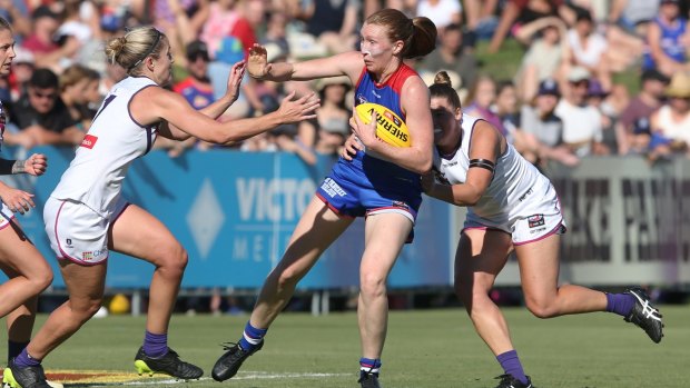 Don't argue: Tiarna Ernst tries to find some space as Fremantle apply pressure.
