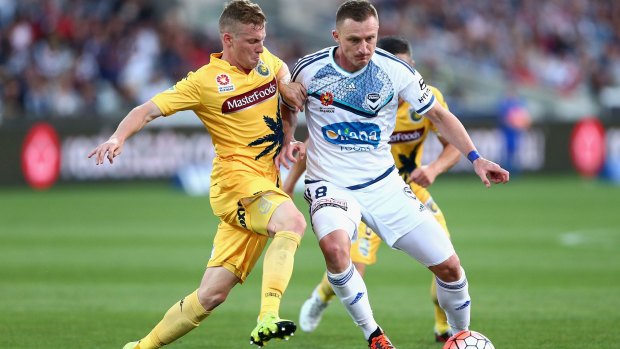 Besart Berisha of Melbourne keeps control of the ball as he is challenged.