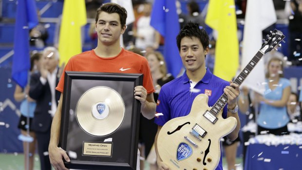 Kei Nishikori, right, and Taylor Fritz pose with their trophies.