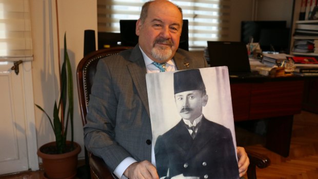 Bahadir Gurer with a photograph of his grandfather, Mahmut Ulkenbay, who was stationed on the Ottoman warship the Barbaros Hayreddin Pasha.