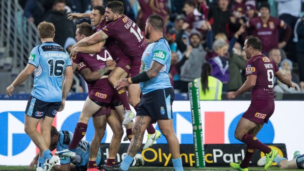Party time: Maroons players mob Dane Gagai after his late try on Wednesday.