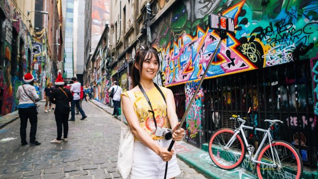 A tourists captures the moment in Hosier Lane using the popular Selfie Stick. 