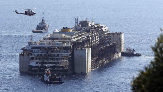 Two-year salvage operation: Tugboats push the Costa Concordia during its refloating on Wednesday.