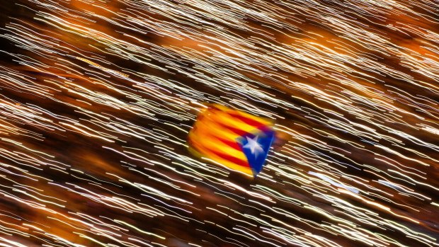 An independence flag is waved in Barcelona as demonstrators take part in a protest calling for the release of jailed Catalan politicians. 
