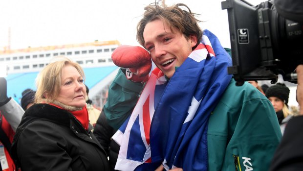 Scotty James celebrates with his mother Celia – and a TV camera – after winning the bronze medal in the men's snowboard halfpipe.