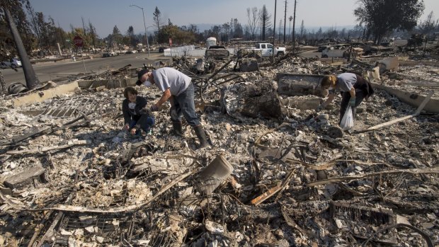 Residents look through rubble of one of about 3000 homes burned in Santa Rosa. The wildfires that tore through northern California's iconic wine-growing regions have become the most deadly in the state's history.