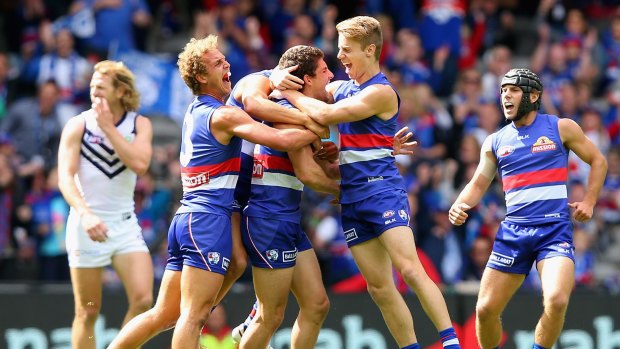 Welcome back: Tom Liberatore receives exuberant congratulations from his teammates.