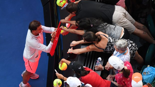 Class act: Rafael Nadal of Spain signs autographs after his win over Diego Schwartzman.