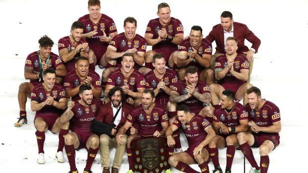 Celebration state: Queensland celebrate with the trophy.