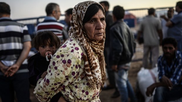 Tens of thousands of Syrian Kurds have flooded into Turkey, fleeing an onslaught by the jihadist Islamic State.