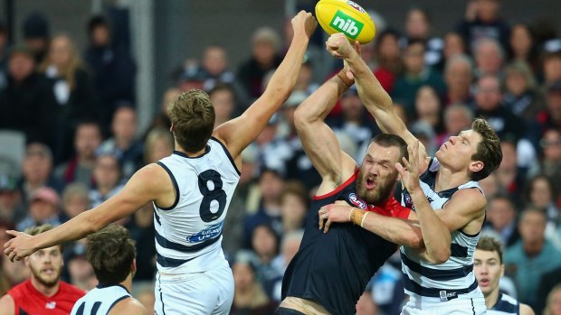 Max Gawn competes for the ball against Jake Kolodjashnij and Mark Blicavs of the Cats.