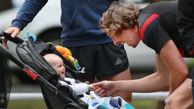 Joe Daniher shares a moment with Brent Stanton's son Aiden at pre-season training.