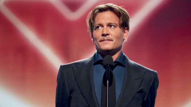 Johnny Depp accepts the Favourite Movie Icon award onstage during the People's Choice Awards in Los Angeles.