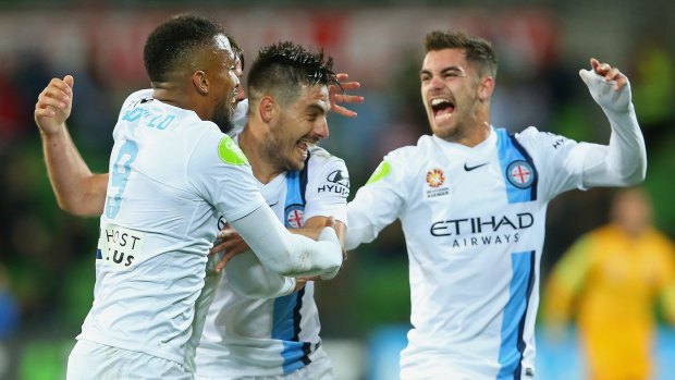 Melbourne City players celebrate a goal by Nick Fitzgerald.