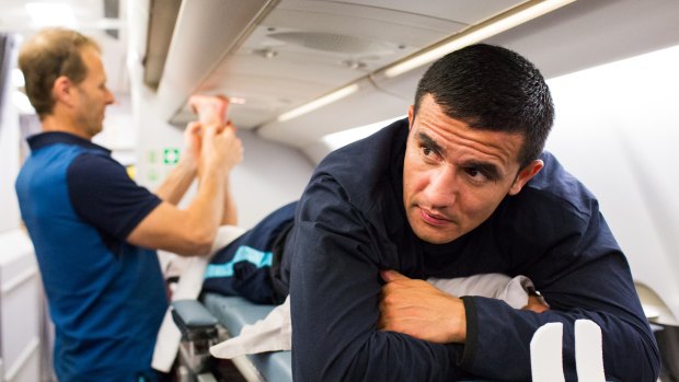 Tim Cahill is treated on board the Socceroos' flight to Honolulu.