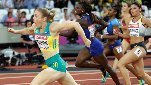 Australia's Sally Pearson, left, crosses the line to win gold in the women's 100-metre hurdles final during the World Athletics Championships in London.