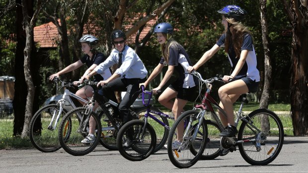 Road Safety Minister Shane Rattenbury rides with students at University of Canberra High School in Kaleen.