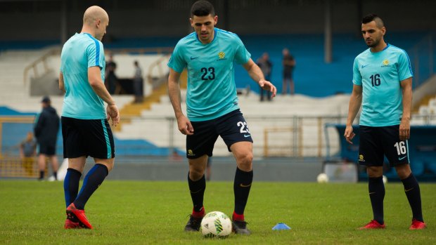 Muggy work: Aaron Mooy, Tom Rogic and Aziz Behich at Socceroos training.