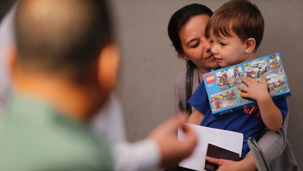 Sabine Atlaoui, the wife of French man facing execution Serge Atlaoui holding their son Yasen Atlaoui, while they wait to visit him on Nusakambangan prison island.