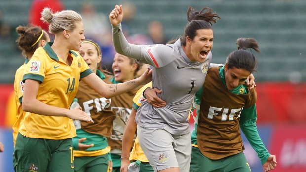 Alanna Kennedy, Lydia Williams and Leena Khamis of Australia celebrate after their draw against Sweden.