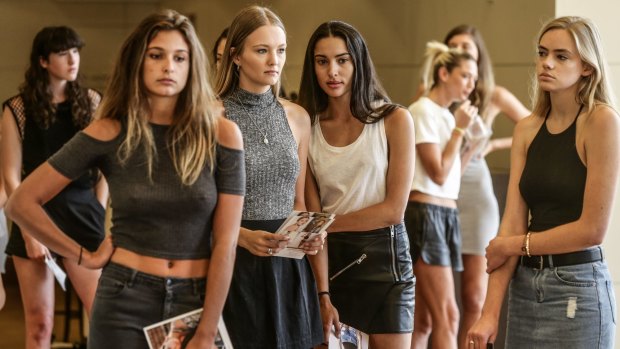 Models wait in line for their turn to walk at the casting.