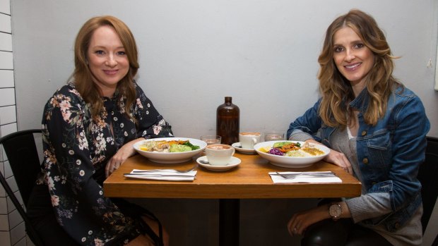 Mandy McElhinney (left) and Kate Waterhouse enjoy a salad at The Roots Next Door.
