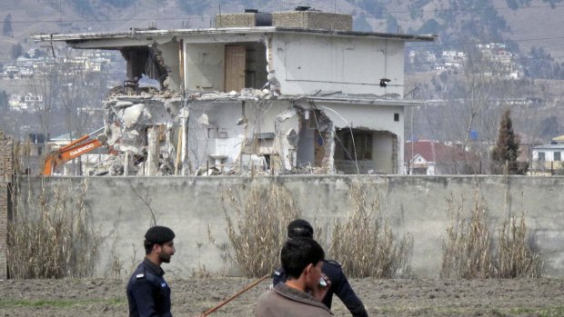 Policemen patrol the area while Osama Bin Laden's final home in the Pakistani garrison town of Abbottabad is demolished in February 2012.