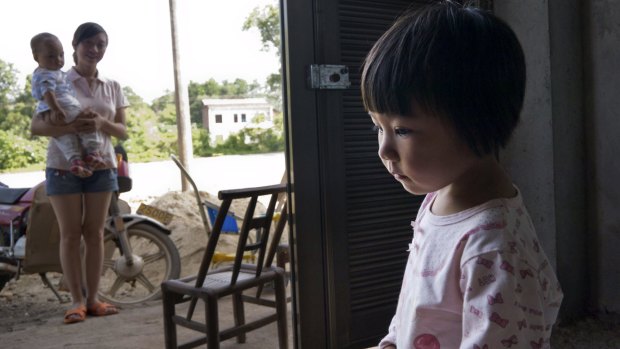 Two-year-old Xu Yilin, whose blood, according to her family, has been shown to have almost three times the national limit for lead exposure in children, in Dapu town, Hunan province.