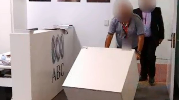 ASIO staff enter the ABC's parliamentary bureau to secure the cabinet files last week.