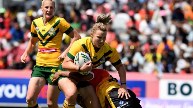 Strong run: Renae Kunst is tackled during Australia's dominant win over Papua New Guinea.