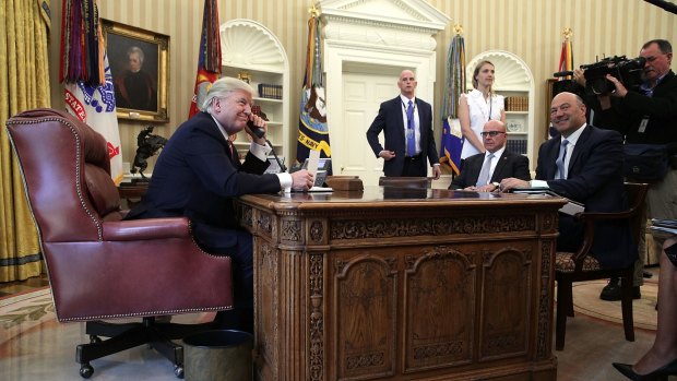 President Donald Trump speaks on the phone with Irish Prime Minister Leo Varadkar in the Oval Office of the White House.