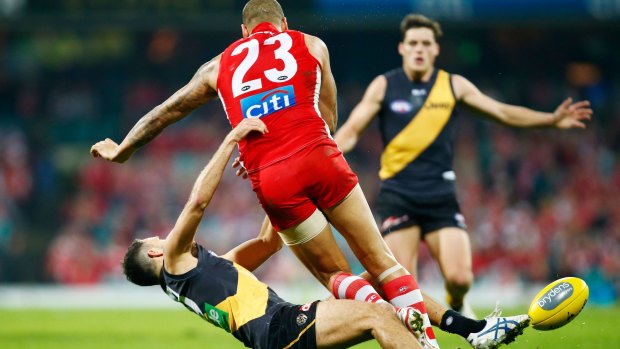Rough justice: Lance Franklin collects Shane Edwards on Friday night.