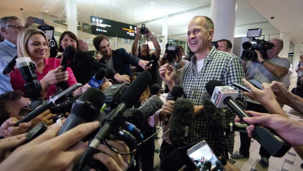 All smiles ... Peter Greste faces a huge media contingent after coming through Customs at Brisbane Airport following his release from prison in Cairo.
