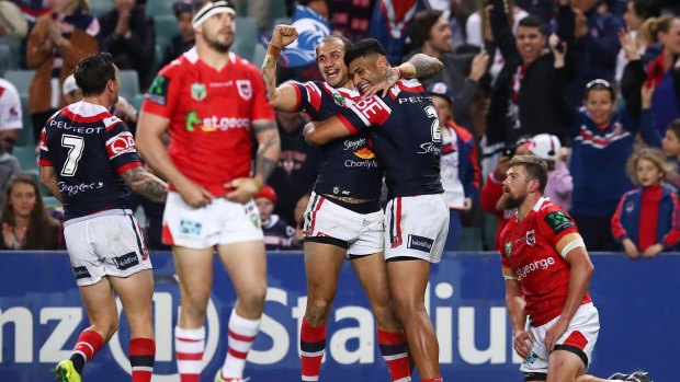 Blake Ferguson of the Roosters celebrates with team mates after scoring a try during the round 24 NRL match between the Sydney Roosters and the St George Illawarra Dragons.
