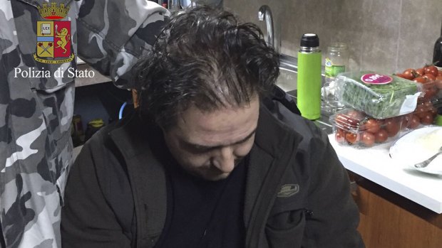 10 years on the run ... Giuseppe Crea, 37, sits in the hidden bunker where he was arrested. Italian police discovered the underground bunker in the countryside of southern Calabria on Friday with two mobsters sleeping inside.