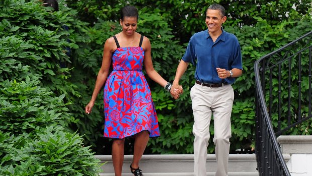Michelle Obama walks with Barack Obama wearing Sophie Theallet at an Independence Day barbeque on the South Lawn of the White House on July 4, 2011 in Washington, D.C. 