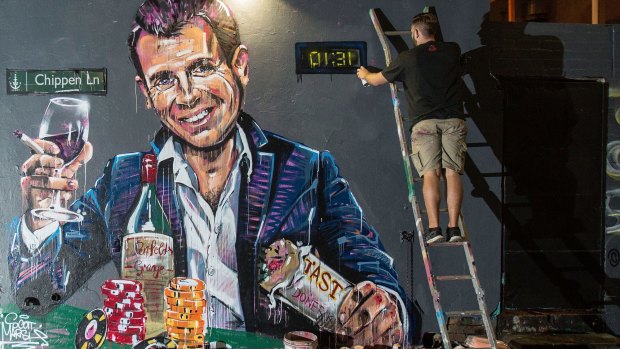 Controversial policy: artist Scott Marsh paints a mural of Mike Baird as a comment on the Sydney lockout laws.