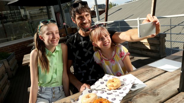 Doughnut fan Andrew ffrench poses for a photo with his daughters Anna and Lucy before tucking into the Doughboys Doughnuts. 